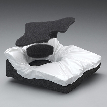 The skin protection qualities of the Java Cushion can be adjusted, if needed, through the use of well inserts (shown hovering above their eventual position, in black).
